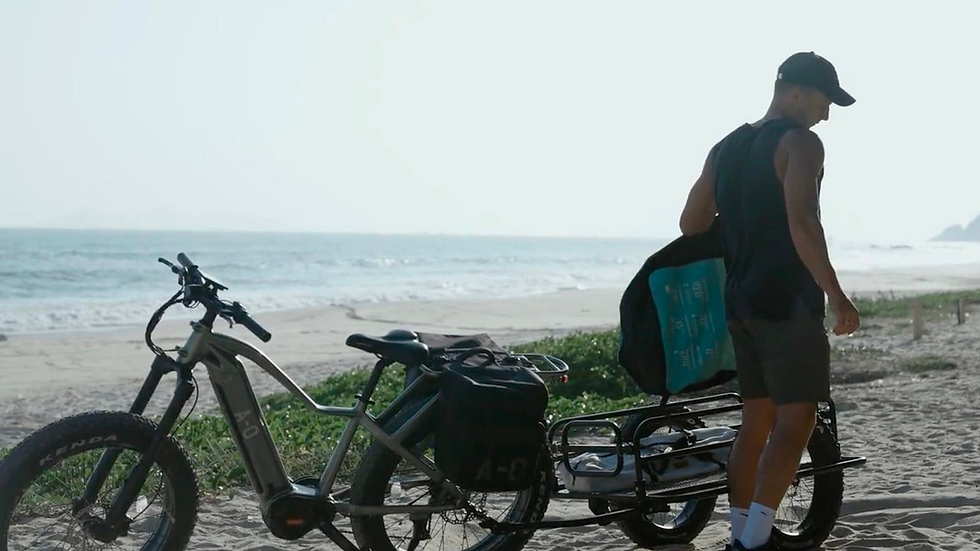 A view of the Ronin with a trailer hitched to the back of it and the rider unloading it.