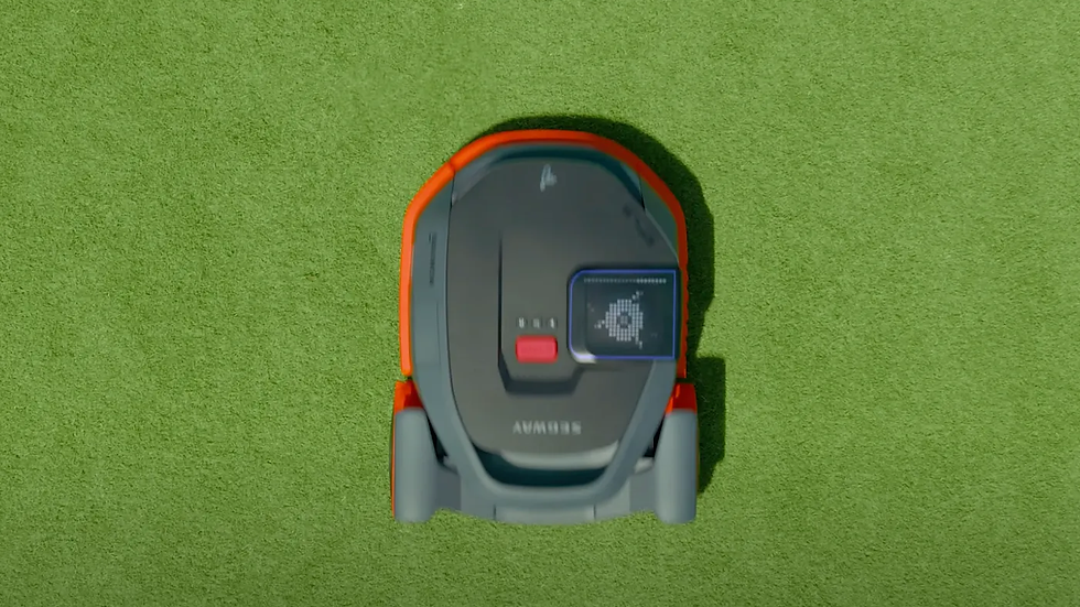 A view from above looking upon a functioning Segway NaviMow Robot mower