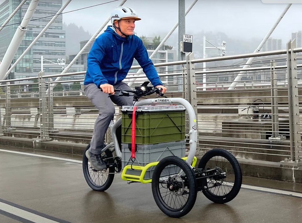 A rider in an urban setting with his Streek x Vvolt e-cargo trike.