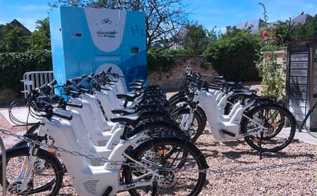 Several Alpha Neo bikes lined up for a re-fueling