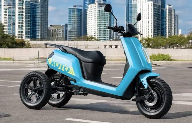 A view of the XOTO three-wheeled electric scooter with a city in the background 
