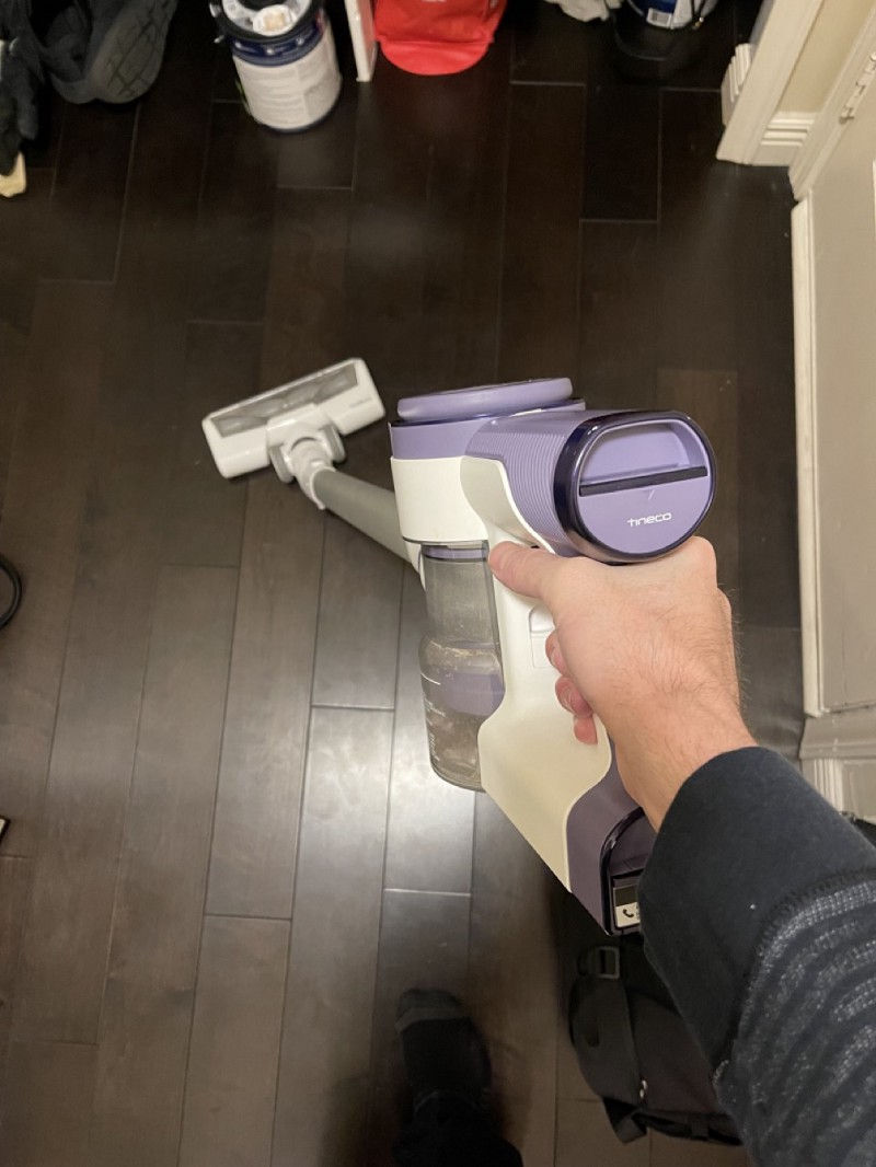 Using the Tineco S12 Pure One vacuum on dark hardwood floors.