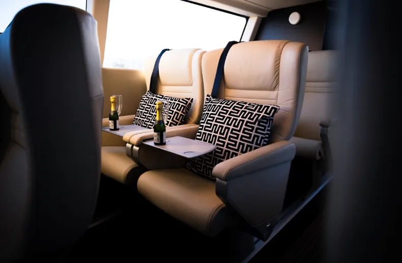 A view of the interior seating and tasting trays within the EF-12 water taxi