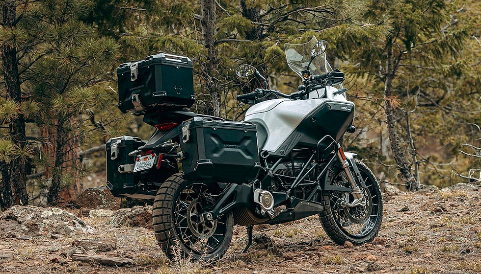 A parked DSR/X electric motorcycle in a rough terrain. 