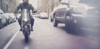 A rider on his Fuell Fllow electric motorcycle doing some driving in the city.