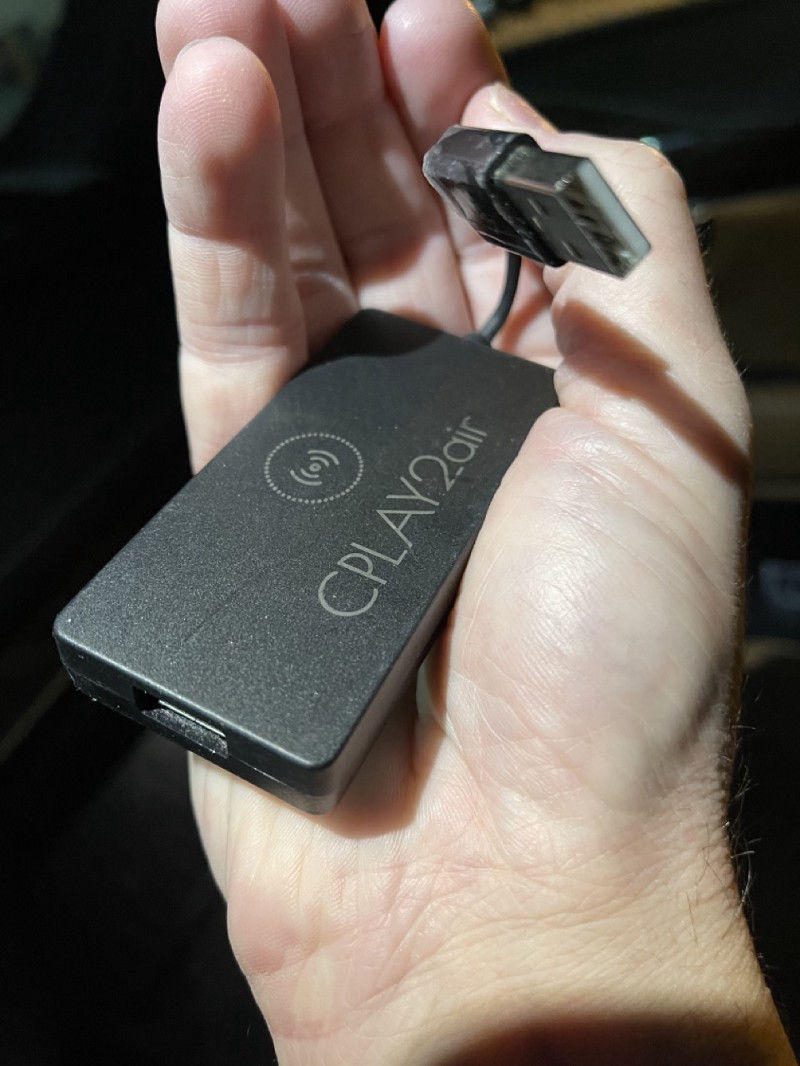CPlay2air controller as it is held in hand to show the small size.