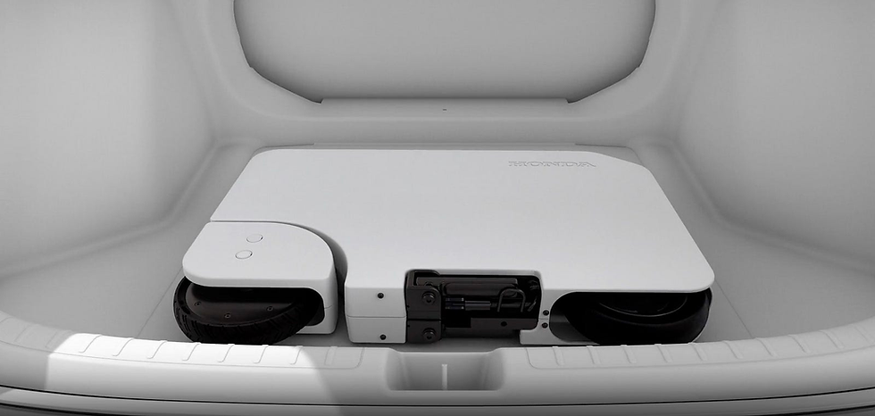 A view inside a trunk with a folded Motocompacto electric scooter.