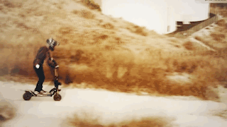A pan-out view of the Wolf GT scooter traversing and off-road path.