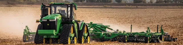 A view of the 9RX John Deere tractor tilling a field. 