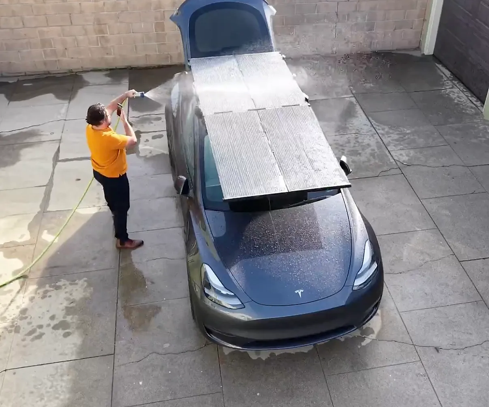 An overhead view showing someone washing the DartSolar EV Solar Rooftop panels