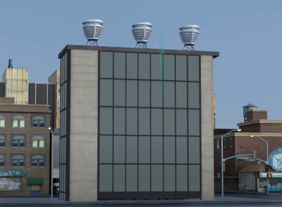 A large commercial building with three wind turbines installed.