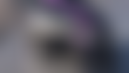 A closer look at a silver and purple AE Motion 4-wheel tilting vehicle on full display