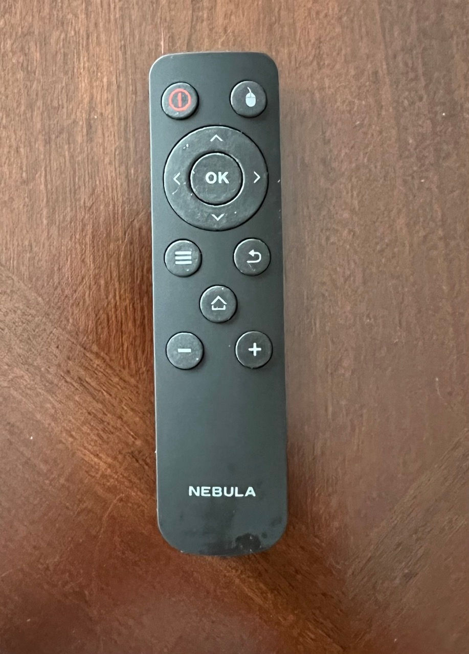 Looking upon the Nebula Capsule remote as it is sitting on a table.
