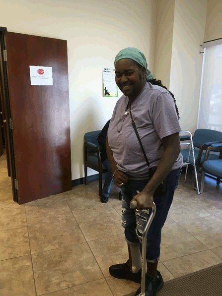 woman walking with a cane and smiling