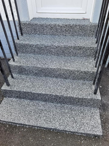 resin stairs with black rail and white door