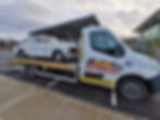 recovery truck with a car on the back