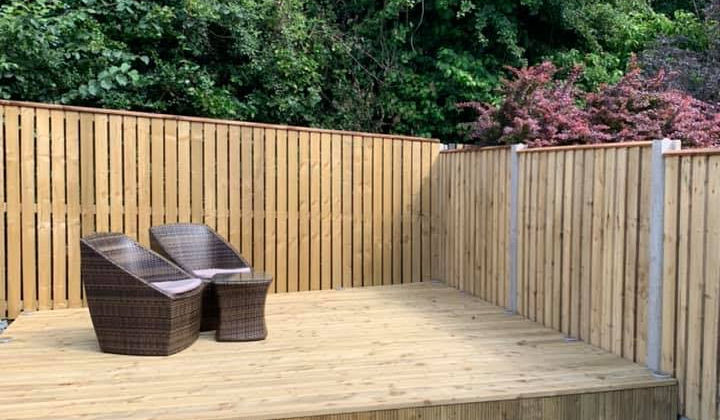 newly installed fence and deck with chairs