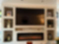 installed media wall with photo frames and tv