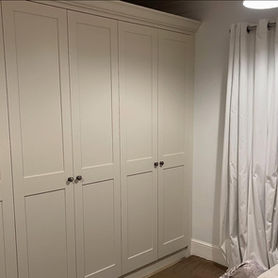 white fitted wardrobe next to window
