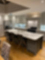 A stylish kitchen with a toaster, hob, oven and kitchen island