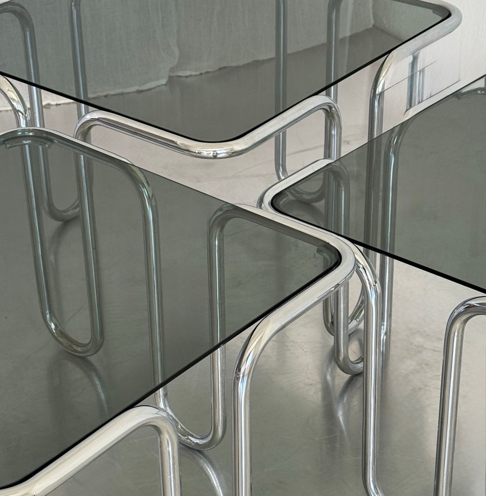 Top angle view of the set of three Ezio Didone nesting tables showing smoked glass surfaces