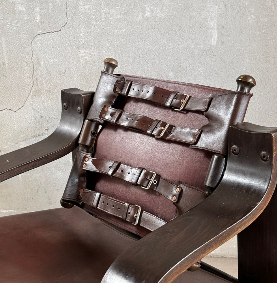 Detailed shot of the robust leather straps and buckles on the rotating backrest