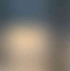Dimmable Baltensweiler HALO Mobil lamp casting a warm direct glow against a wall