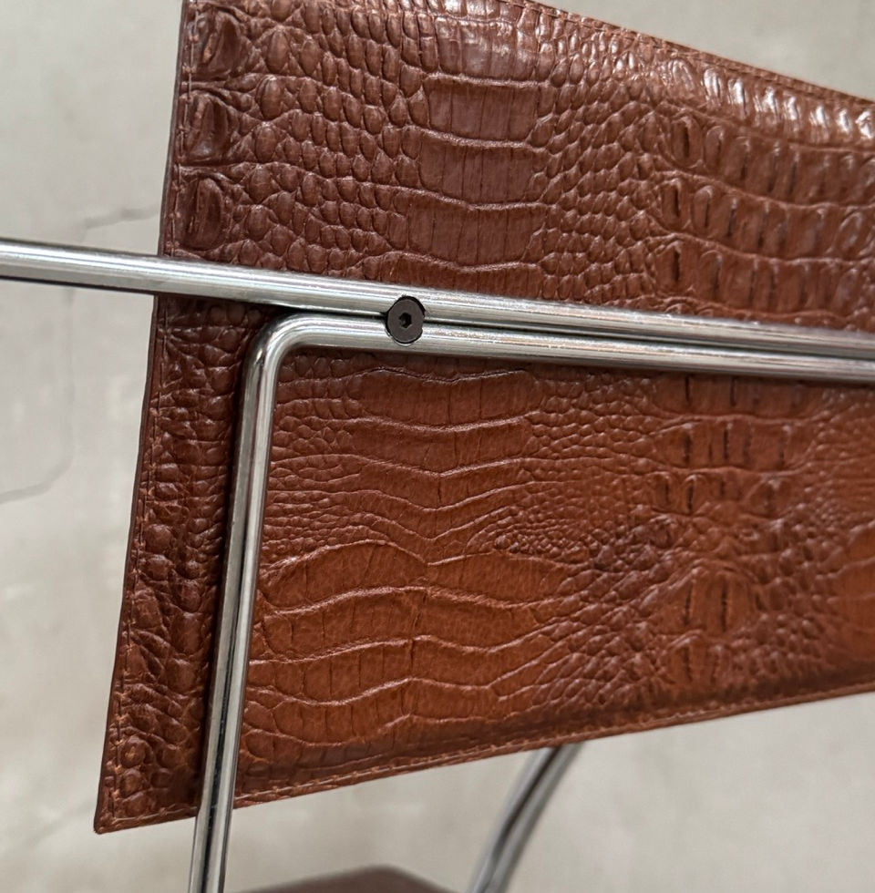 Rear view detail of the chrome metal frame and leather backrest