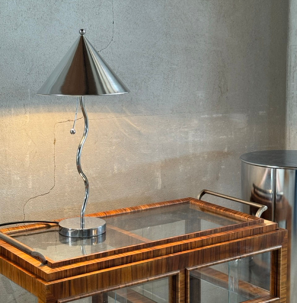 The vintage postmodern metal lamp illuminated, creating a warm atmosphere in a classic home setting