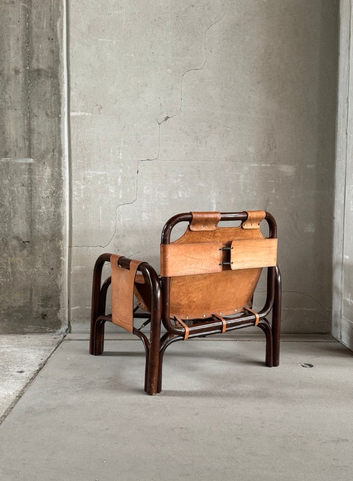 Detail shot of the lower legs and structural frame of the vintage Bonacina armchair