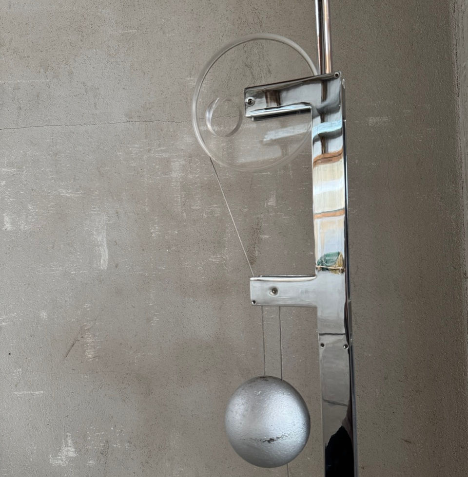 Close-up macro shot of the precision counterweight mechanism and chrome hardware