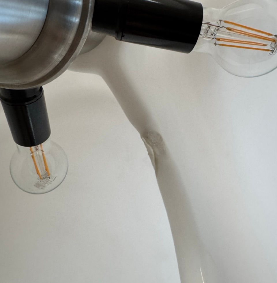 Detailed view under the Pipistrello's methacrylate diffuser showing the internal socket and structural frame