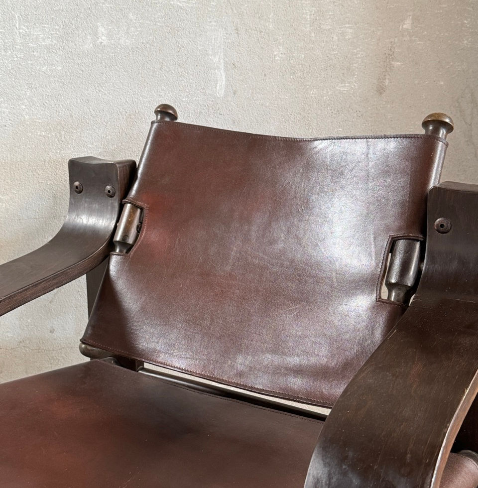 Close-up of the heavy saddle leather sling seat construction on the wooden frame