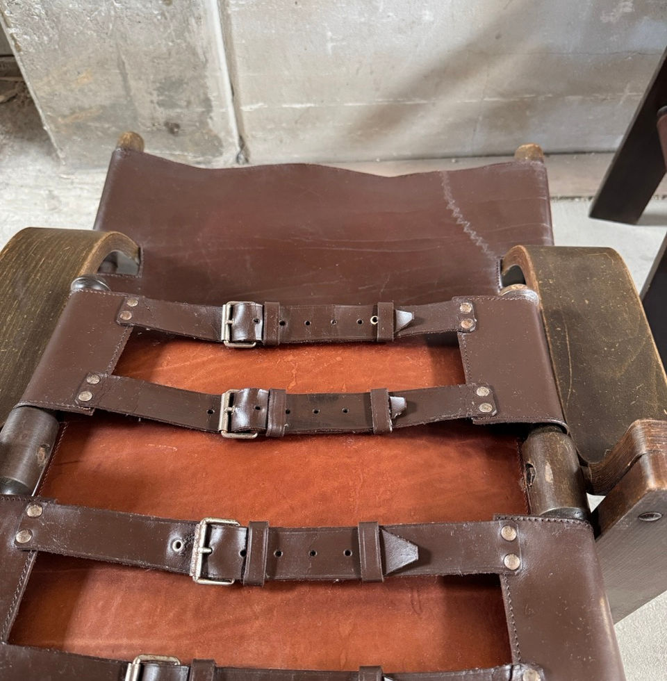 Close-up of the exposed buckle and strap details on the second leather safari chair