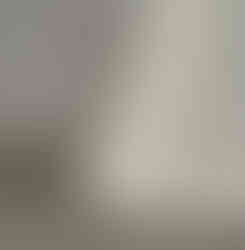Macro detail showing the base of the white conical stand and the precise floor edge contact of the lamp