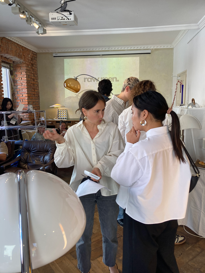 Guests chatting and discovering unique lighting and furniture at the pop-up event.