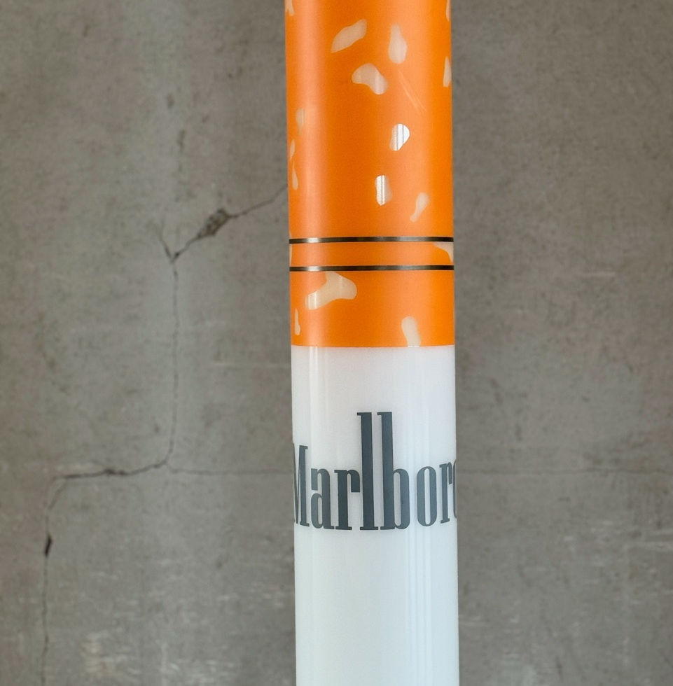Detailed close-up view of the classic white Marlboro logo on the orange tip of the lamp