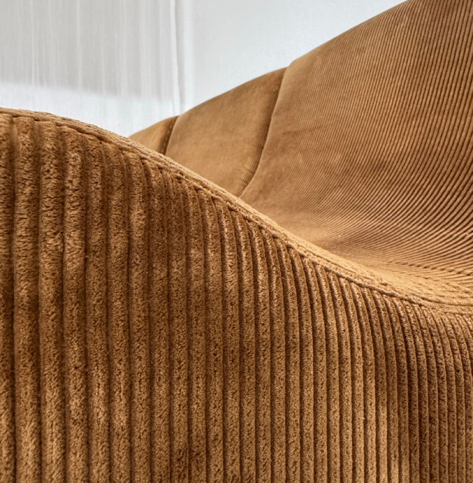 Close-up detail of the continuous flowing organic curves on the COR Orbis sofa