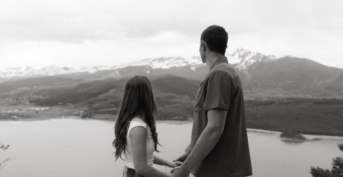 A couple looking over Sapphire Point overlook during their engagement session