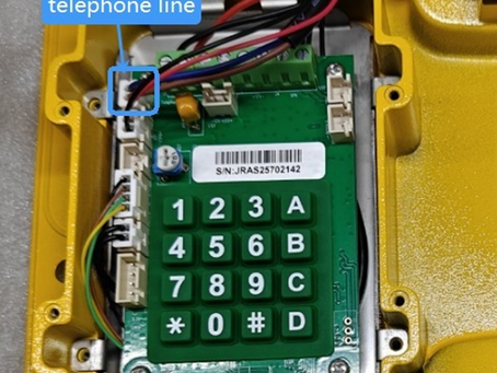 Two-wire connection of an industrial all-weather analog phone (FXO) to an FXS wall port via a weatherproof junction box, showing tip and ring wires. Alternative connection options include direct FXO jack or RJ‑11 plug