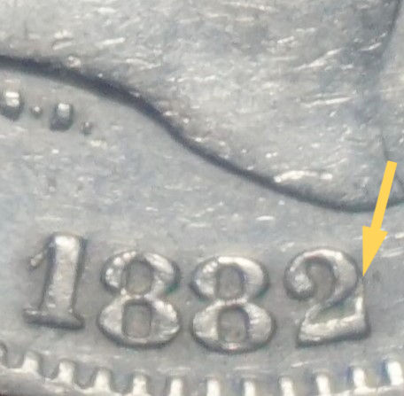 Close-up of 1882 Spanish-Philippine coin date showing an overdate, highlighting a collectible mint variety from the Manila Mint period.