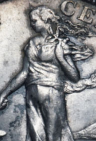 Close-up detail of the standing Filipina figure from a 1903 U.S.-Philippine 50 centavos silver coin showing toned surface and design details.