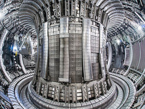 Joint European Torus vessel Interior viewed from Octant 1 Port at the end of the 2012/13 Tile Exchange Shutdown - May 2013. The mascot robot is visible on the left.