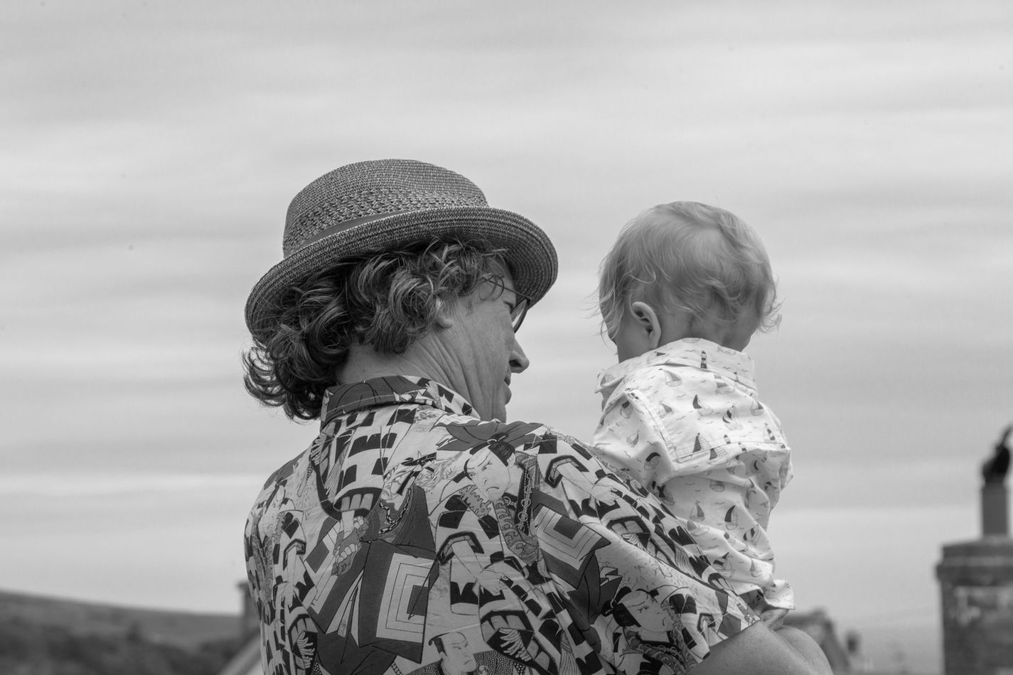 black and white picture of a man holding a baby taken by Ryan Mero Photographer