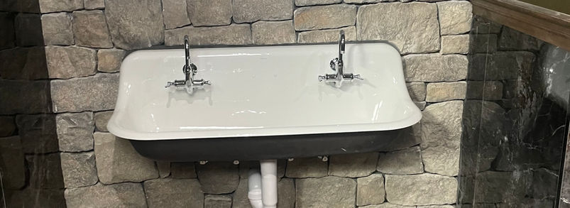 Plumber installing new piping during a commercial tenant improvement project.