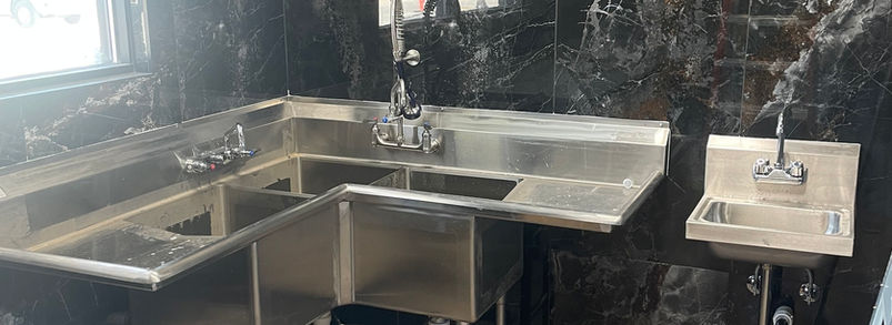 Plumber installing new piping during a commercial tenant improvement project.