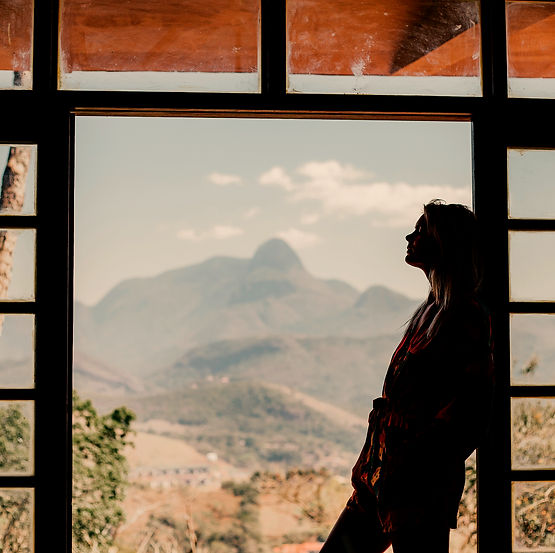 woman looking out window representing erp in california