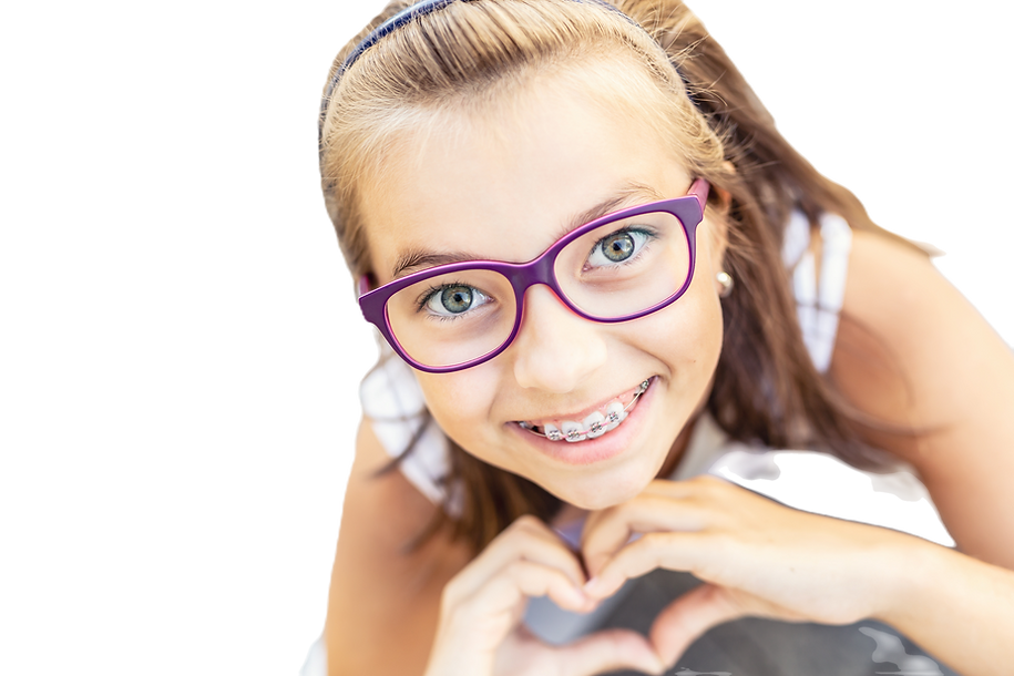 Young preteen girl in glasses wearing braces smiles at the camera showing heart shape with