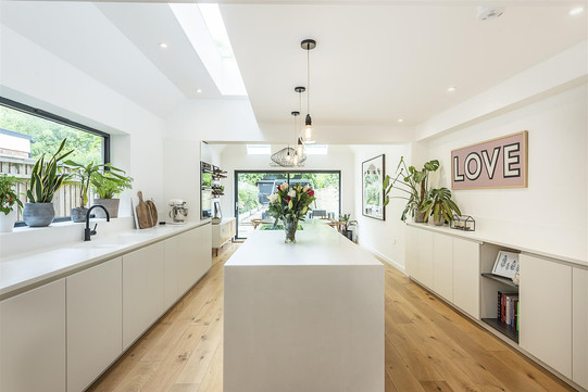 Bright modern kitchen with island and large windows