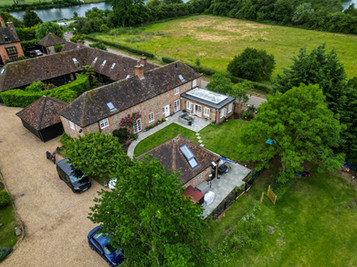 Aerial view of countryside property with multiple buildings